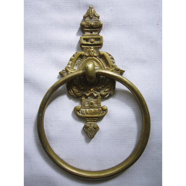 Vintage Cast Brass towel holder. The back measures 6.5"H x 4"W and the ring is 6"D. It is in excellent condition. Height...
