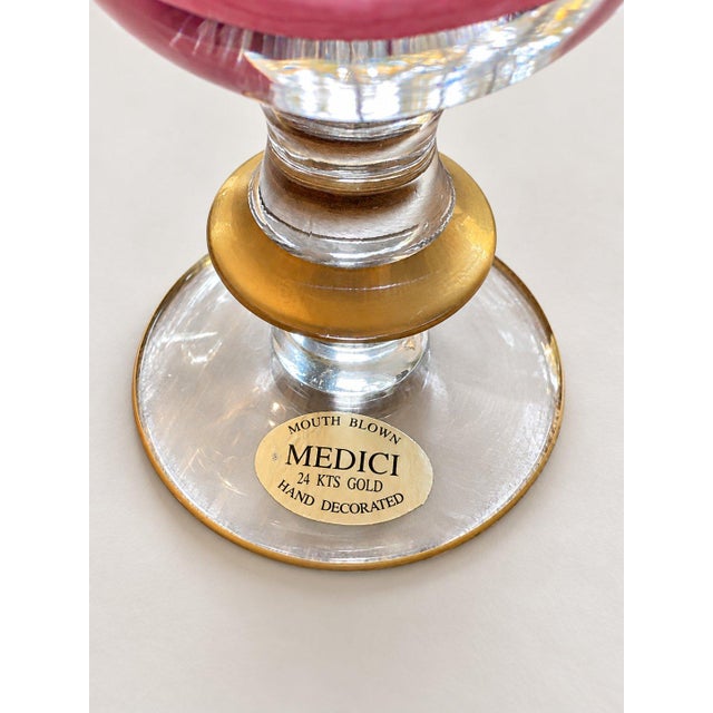 Medici mouth blown pink glass goblet with 24 kts gold hand decorated accents, featuring an elegant gold garland pattern. -...