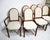 A set of eight teak framed dining chairs with comfortable upholstered seats and backs including six side chairs and two...