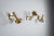 This refined set of three vintage brass wall lamps exemplifies understated luxury and sculptural design. Each piece is...