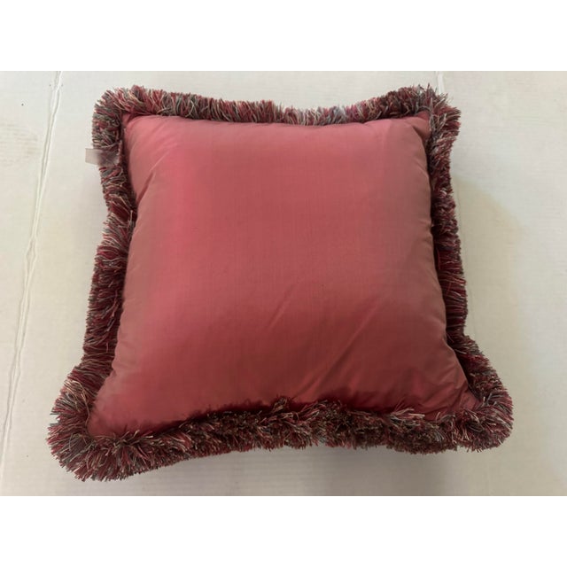 A charming floral pillow in a Pierre Frey fabric having feather-like ribbons cascading throughout in tapestry stitching....