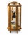A composed vintage curio cabinet in warm oak, defined by its curved glass silhouette, twisted columns, floral carving,...