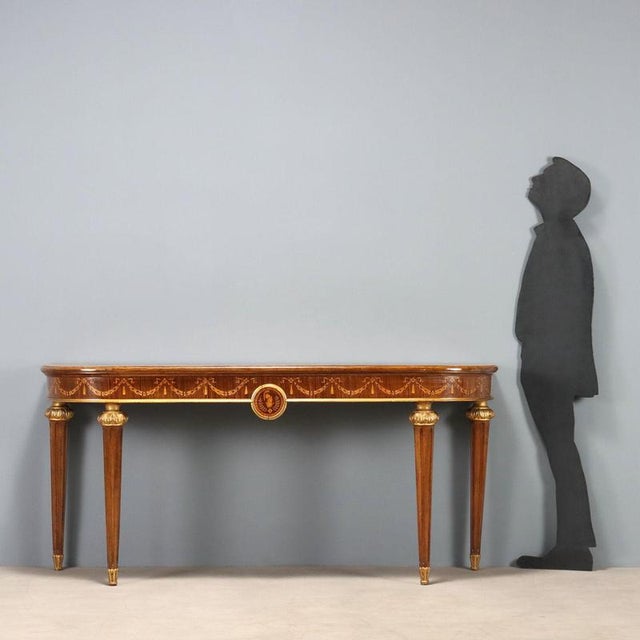 Neoclassical-style walnut console table. Top with maple frame, maple and rosewood trim, central medallion, and inlaid...