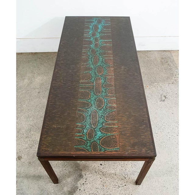 Unique John Morkegaard designed rosewood and copper etched coffee table. Abstract design on top with rosewood frame....