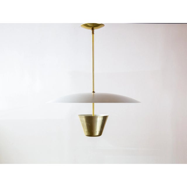 A simplistic form from Edward Wormley for lightolier. The white cup allows for light to diffuse through perforations as...