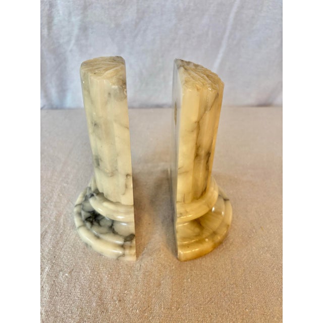 This pair of Mid 20th Century Bookends were hand carved in the Grand Tour style from alabaster in Italy in the mid 1900's....