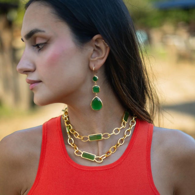 Bring elegance and versatility to your jewelry collection with the Versatile Glow Green Cat Eye Gold Long Necklace. This...