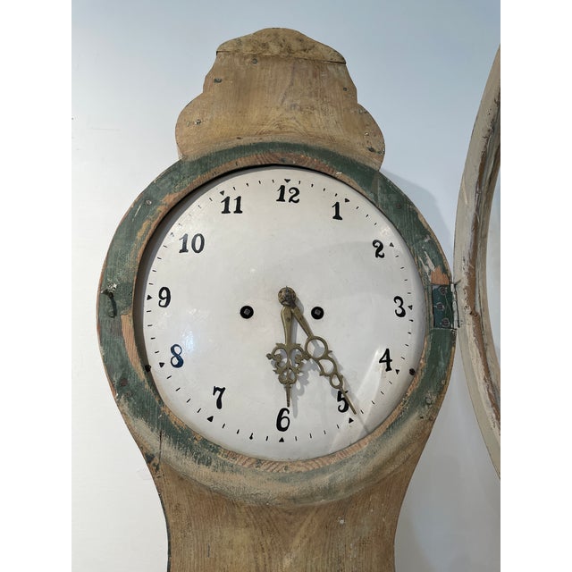 Finished with its original painted surface, the clock features the elegant, elongated silhouette characteristic of Mora...
