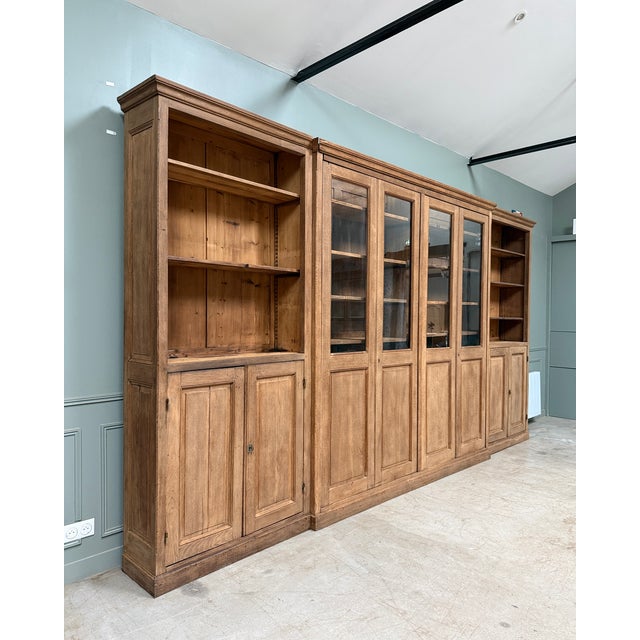 Imposing and majestic, this antique solid oak bookcase impresses with its spectacular dimensions and timeless elegance....
