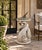 A striking vintage neoclassical garden pedestal featuring three intertwined dolphins supporting a shallow circular basin....