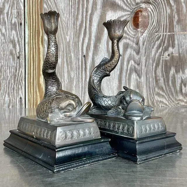 Illuminate your space with this captivating pair of vintage Hollywood Regency cast dolphin candlesticks, embodying aquatic...