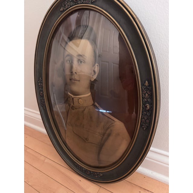 A striking antique portrait of a young U.S. officer, presented beneath convex glass that creates a subtle dimensional...