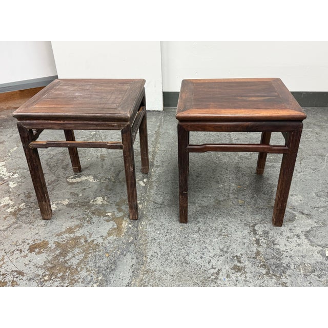 Design Plus Gallery presents a Pair of Vintage Asian Rosewood Side Tables. The pair has square paneled tops, mitered...