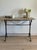 Rectangular marble top in soft cream and pink veining, propped on a cast iron base of scrolled supports joined by a turned...