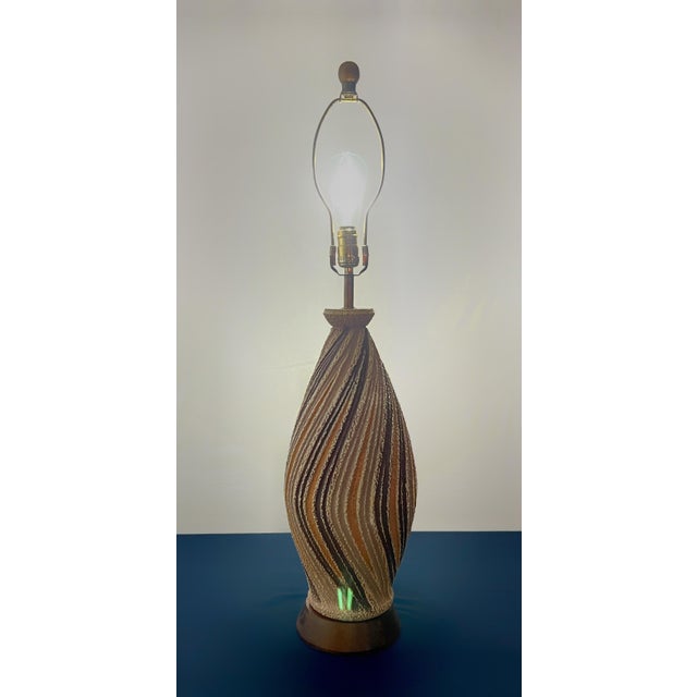 A striking 1970s mid-century modern sculptural table lamp manufactured by F.A.I.P. (Fine Arts in Plastic). This monumental...