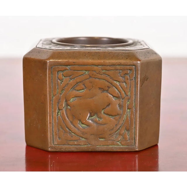 An authentic Tiffany Studios antique bronze pen or brush cup holder in the iconic Zodiac design. Clearly signed by Tiffany...