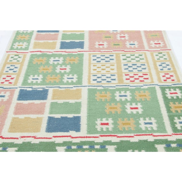 A rich new addition to the Rug & Kilim’s Scandinavian Collection, this 5x7 rug is handwoven in a new flat weave...