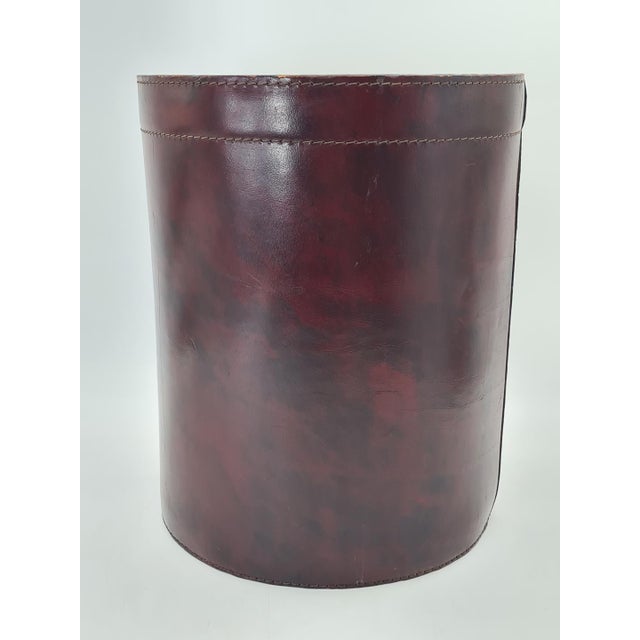 An elegant, vintage wastebasket made of natural leather in a deep burgundy-brown color. Manufactured by the German company...