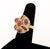 18K Yellow Gold, Ruby, and Diamond Ring, featuring one bezel set round ruby cabochon, adorned further by three bezel set...