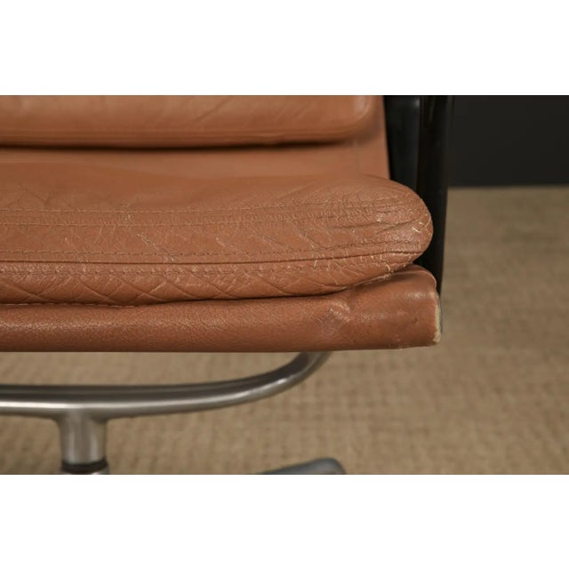 A classic of modernist comfort, this vintage "early production year" model EA-416 swivel lounge chair by Charles and Ray...