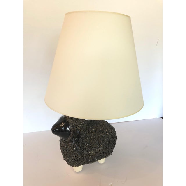 An absolutely adorable table lamp having a handmade sculpture of a wooly sheep and new parchment shade and silk cord.