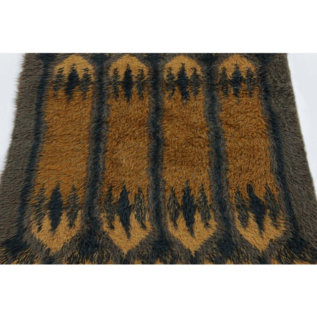 Hand-knotted in lush, high-pile wool in Sweden circa 1960-1970, this 3x5 vintage Swedish Rya rug is a bold new addition to...