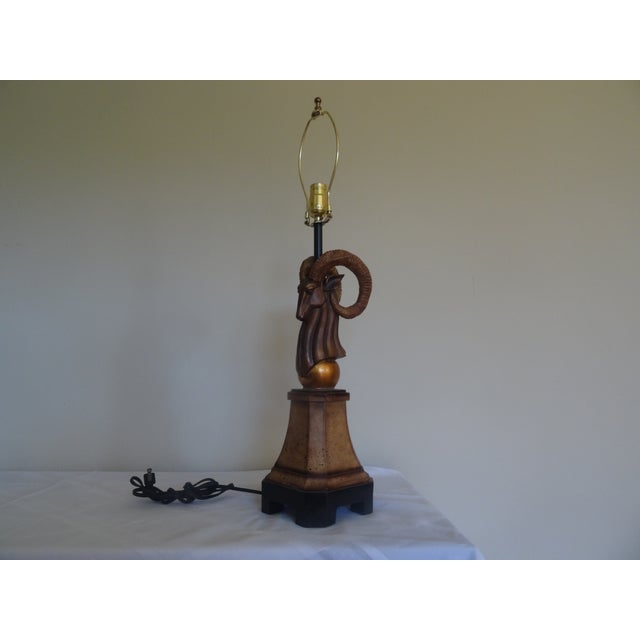 A whimsical lamp in the form of a Ramshead. No shade included