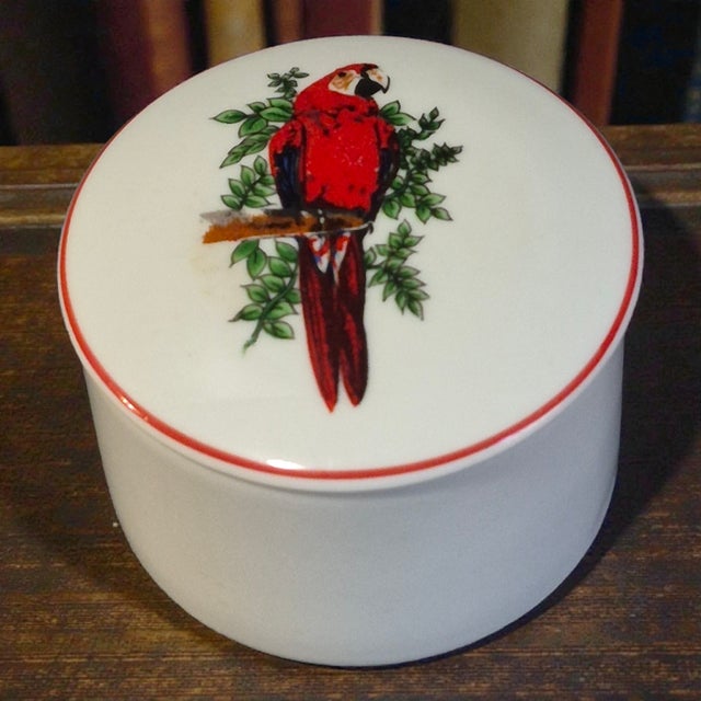 The Vintage Fine Porcelain Leart Brazil Tropical Birds Red Macaw Parrot Trinket Box is a small, round collectible made of...