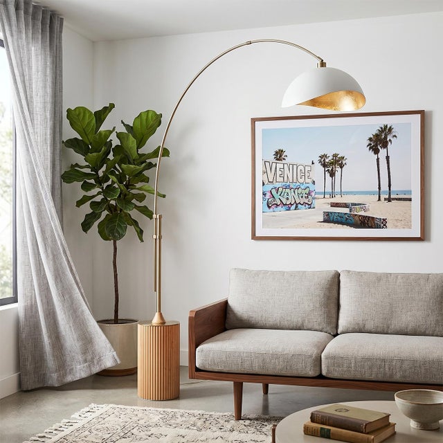 The Tambo Arc Lamp is a dimmable mid-century modern lighting piece designed by Peter Morelli in 1984. This elegant arc...
