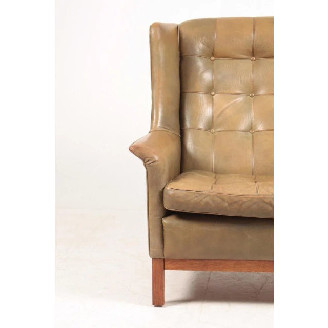 Lounge chair in patinated leather designed by Arne Norell and made by Norell Möbel AB in Sweden. I have official proof of...