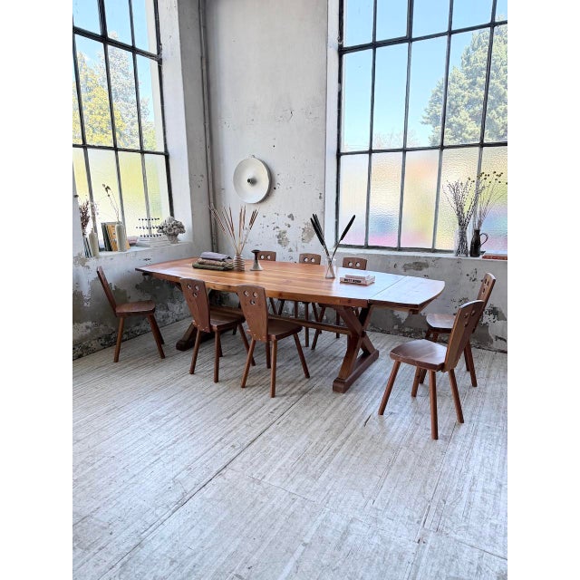 Set comprising a large table with extensions and eight chairs in a mountain style. inspired by swedish design, reminiscent...