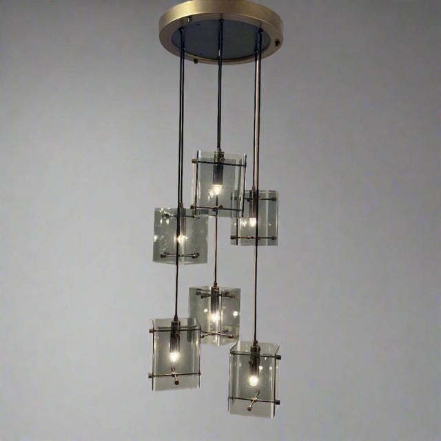 An Italian six light pendant chandelier. Smoked glass, ebonized wood and brass details.