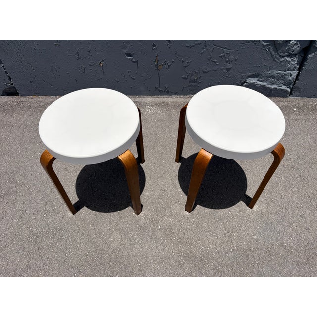 Pair of Thonet Bentwood and Bakelite Stacking Stools. The white bakelite tops are 14" in diameter. Both stools are signed,...
