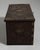 A decorative chest featuring brass detailing that enhances its visual richness. The piece combines storage with historical...