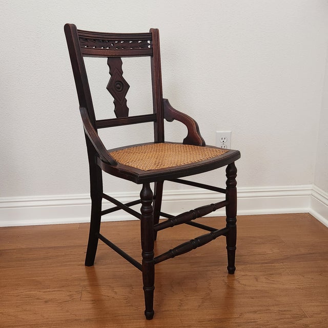 This cute little Eastlake chair is in great condition. It features spindle turned front legs, double stretchers on each...