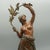 A late 19th century bronze sculpture of a scantily clad lady holding a branch with birds perched upon it. With a shawl...