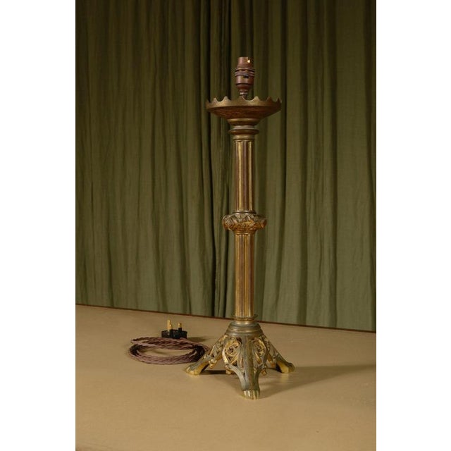A very stylish Gothic Reform gilt brass table lamp, with raised and pierced decoration on a triform base, dating to the...