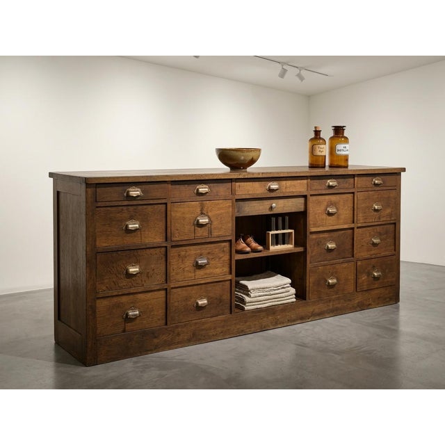 An exceptional and highly functional French apothecary counter (meuble de métier / comptoir de pharmacie), dating from...