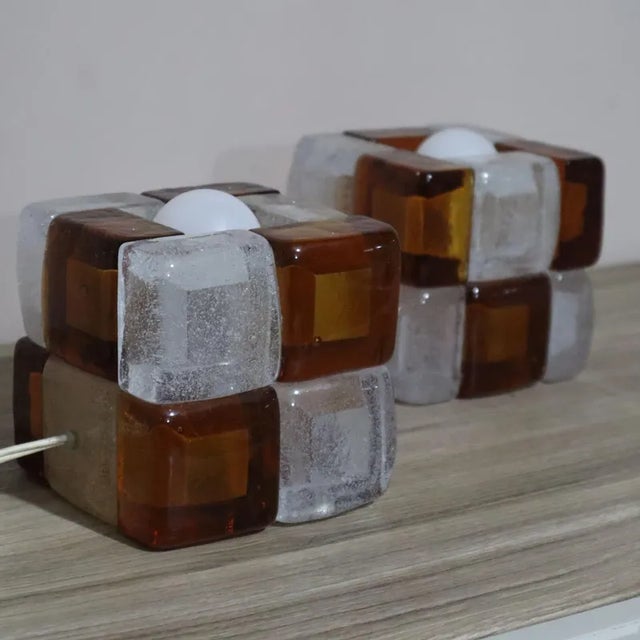 The Poliarte lamps in caramel and transparent glass are unique pieces that combine refined aesthetics and functionality....