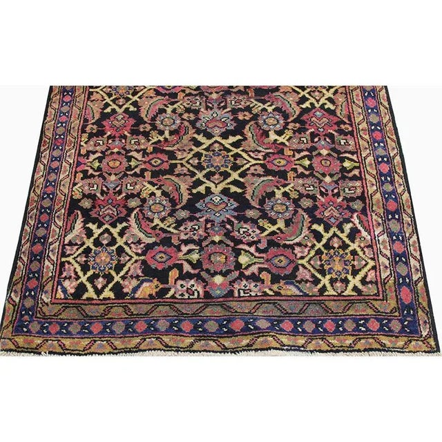 Traditional Old Handwoven Persian Mahal Area Rug featuring an allover design in a black-colored field enclosed in a navy-...