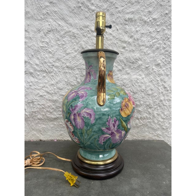 Hand painted porcelain lamp with wood cap and base manufactured by Fredrick Cooper, Chicago. The lamp retains its original...