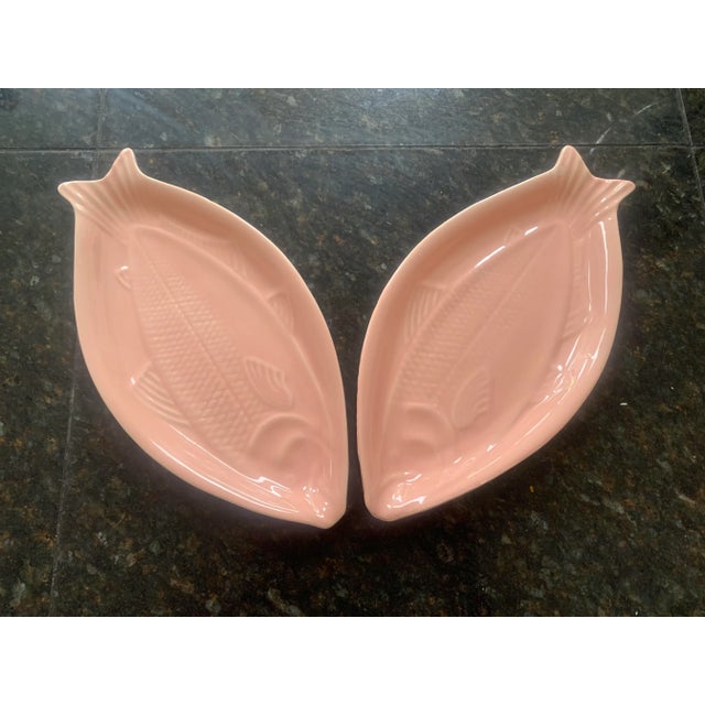 A pair of matching, rose-pink, ceramic fish platters. Or should we call them salmon plates? These platters are mid-century...