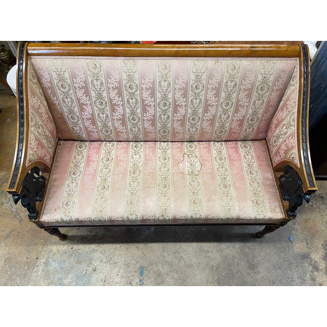 An antique Swedish Empire or Gustavian style settee dating to the late 19th century. It has a structured, straight high...