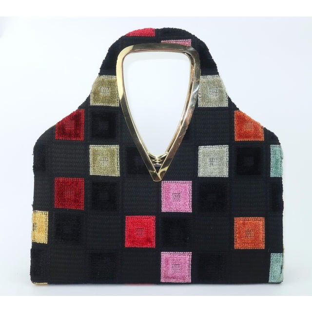 1960's Lewis handbag with a mod 'swinging sixties' black cut velvet pattern accented with squares of pink, burnt orange,...