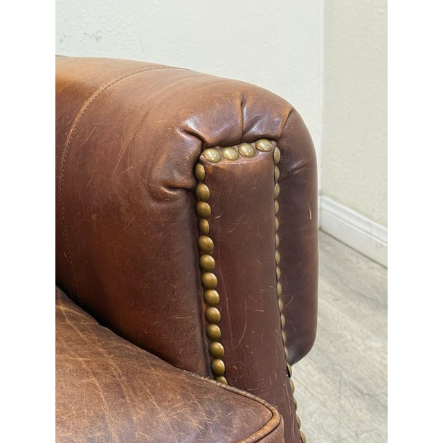 Beautiful leather chair with matching ottoman in good vintage condition.