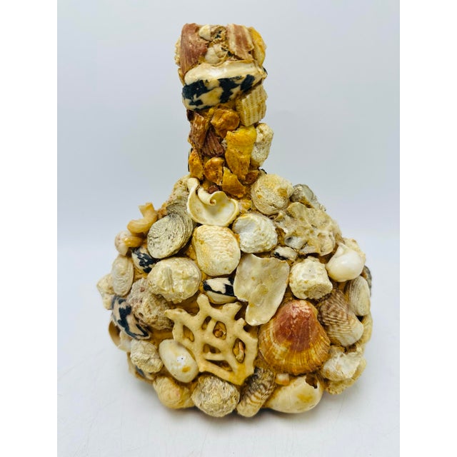This is a vintage shell art bottle, beautifully encrusted with an eclectic assortment of natural seashells. It’s a classic...