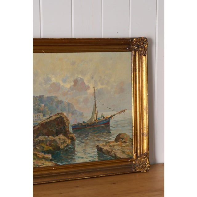 Original mid-century oil on canvas depicting a harbor scene, presented in a giltwood frame.