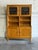 This tall oak hutch in style of Henning Kjærnulf combines enclosed and open sections in a balanced vertical form. Two...