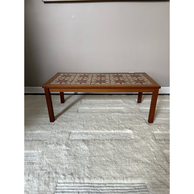 Gorgeous Scandinavian (Danish) solid teak and ceramic tile top coffee table. The frame of this coffee table is made of...