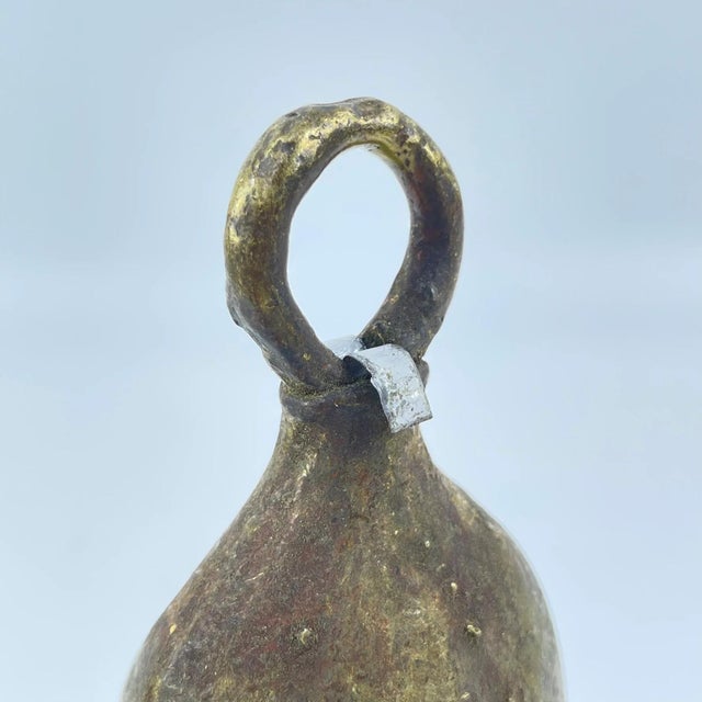 The brass metal bell was crafted by the Benue and Chamba artisans and metalworkers of Nigeria. These bells were often used...